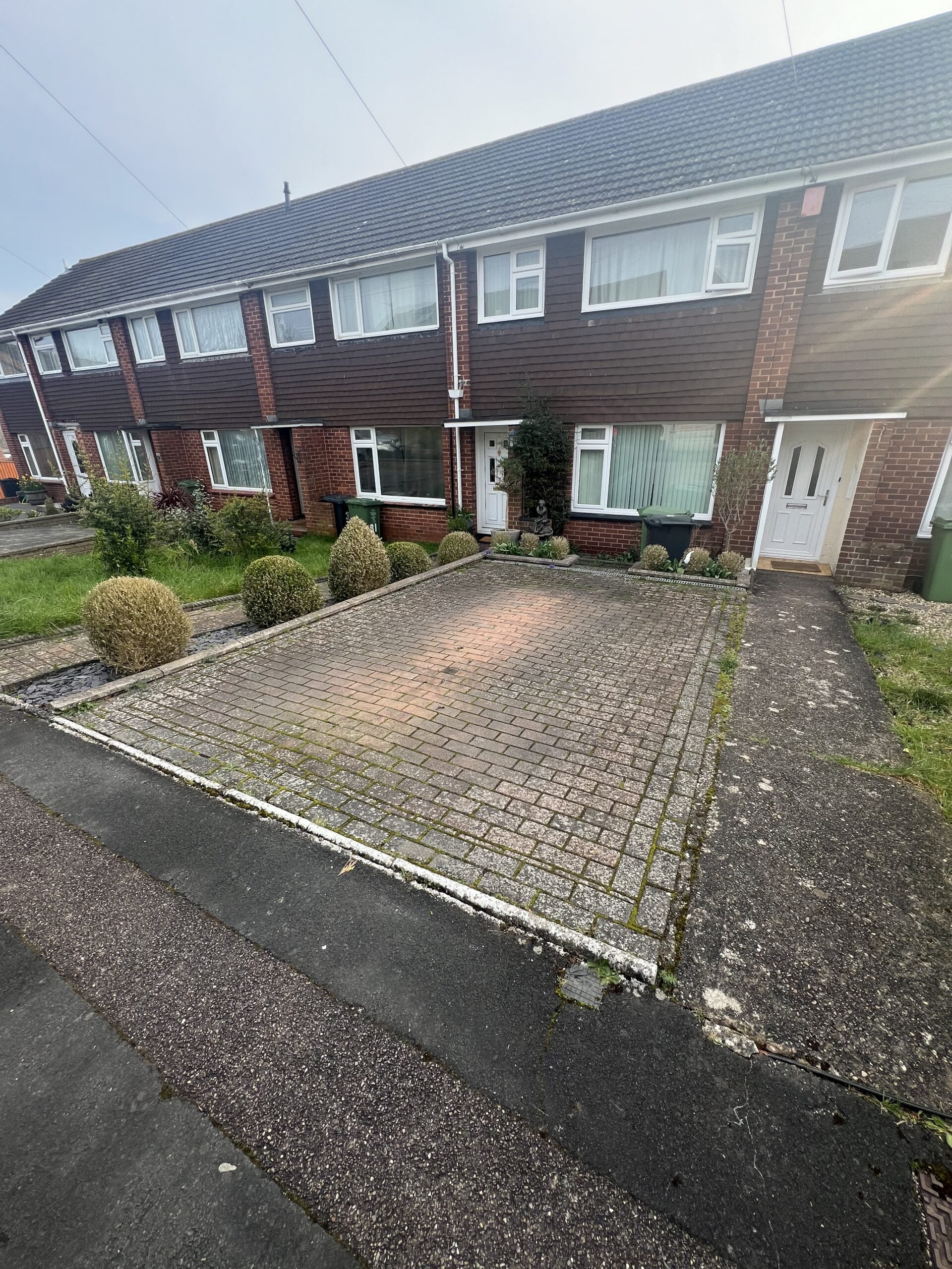 Driveway cleaning in Exeter — BEFORE: heavy dirt, algae and patchy staining on paving